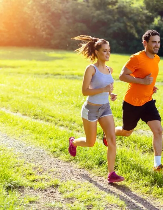 Athletic Couple Jogging In Nature